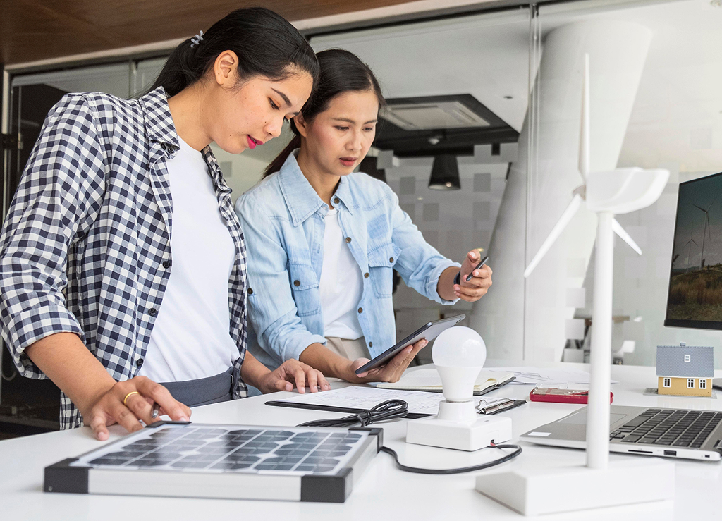 Women brainstorming and coming up with new business innovations at a desk